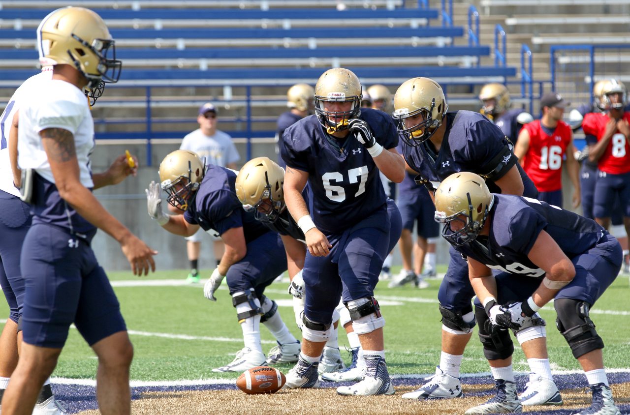 MSU offensive lineman Jake McFetridge (67) working at center/by Brooks Nuanez