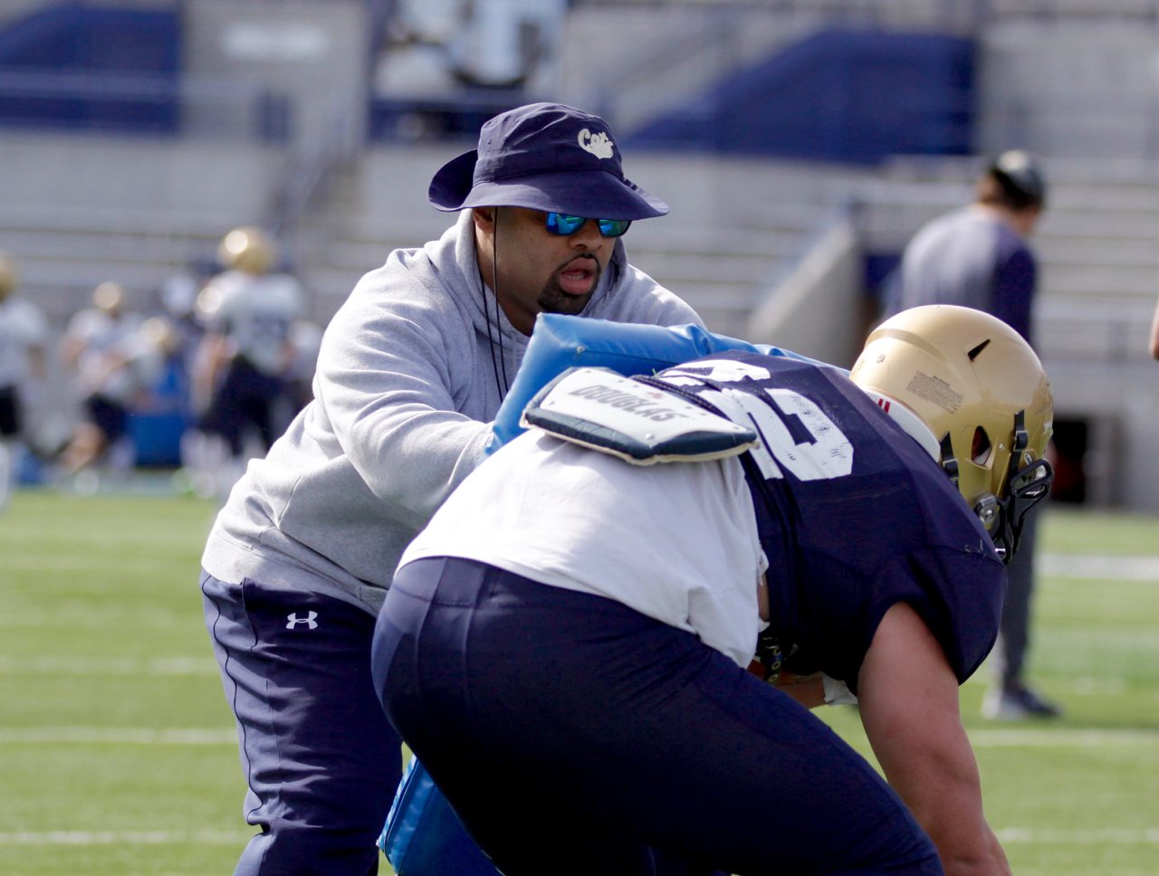 MSU running backs coach Michael Pitre working with running back Noah James (22)