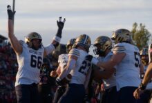 Adam Jones celebrates a touchdown with Titan Fleischmann and the Bobcat linemen