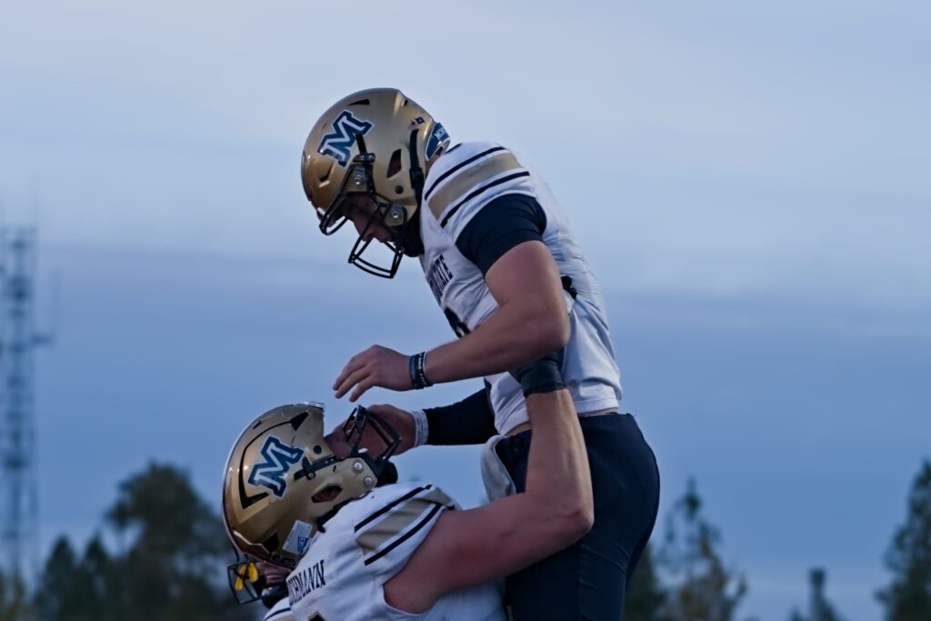 Justin Lamson lifted by Fleischmann after a touchdown