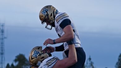 Justin Lamson lifted by Fleischmann after a touchdown