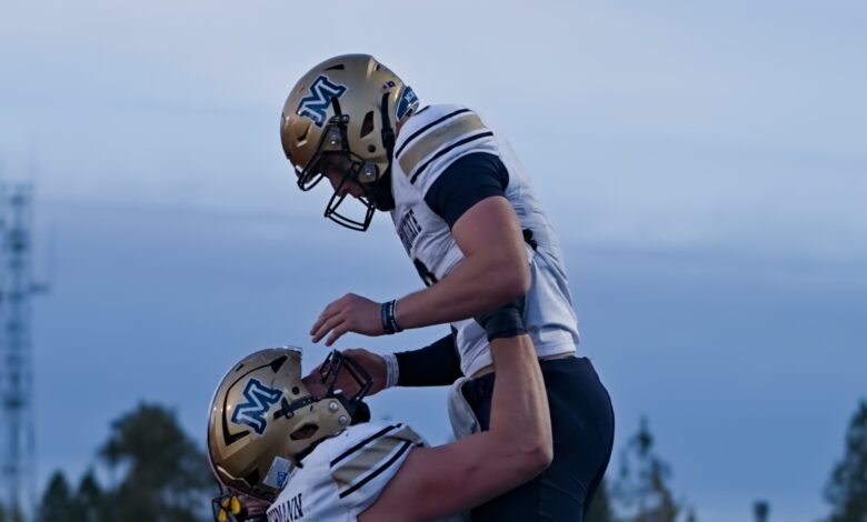 Justin Lamson lifted by Fleischmann after a touchdown