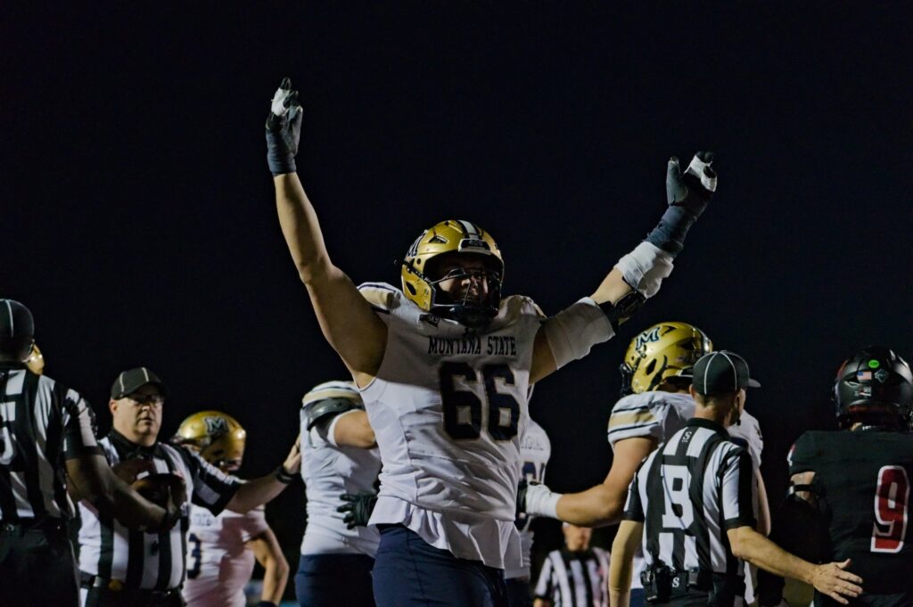 Titan Fleischmann celebrates a touchdown under the lights
