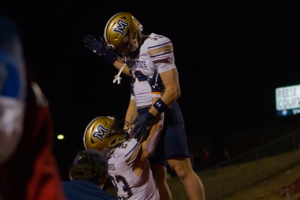 Adam Jones lifts Carter Dahlke after a touchdown