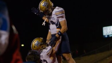 Adam Jones lifts Carter Dahlke after a touchdown