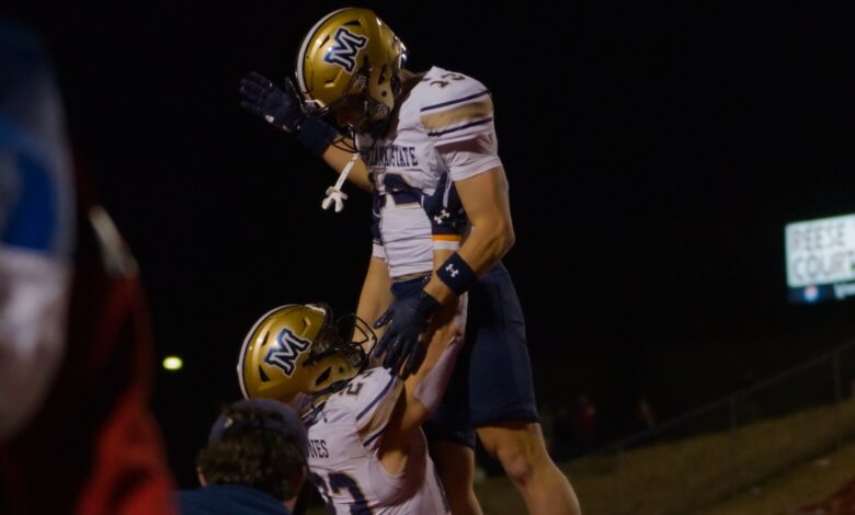 Adam Jones lifts Carter Dahlke after a touchdown