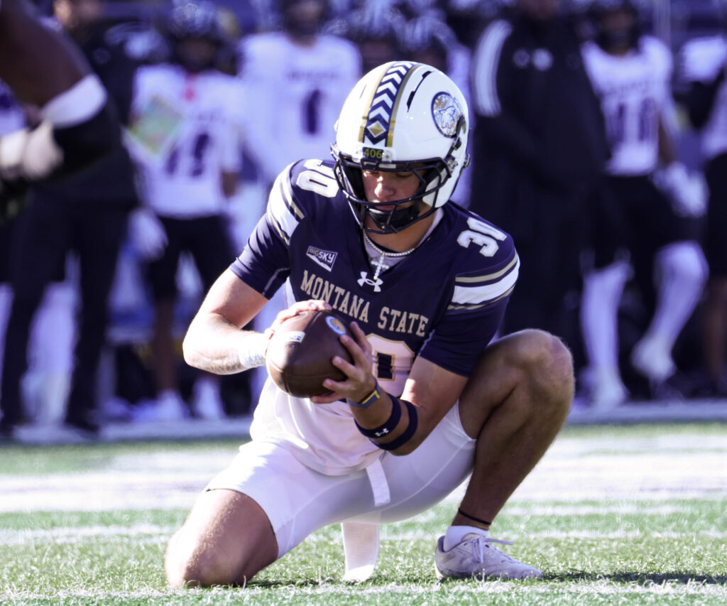 Colby Frokjer holds for a kick