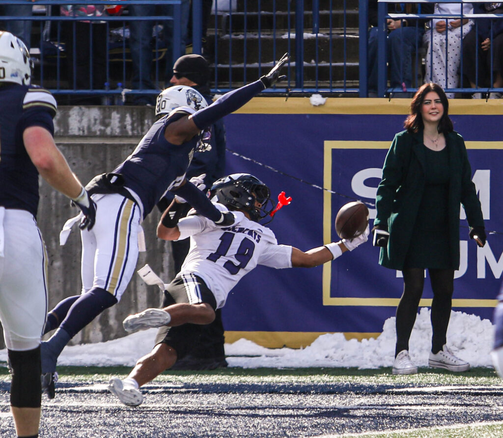 Jasean Mayberry defends a pass near the sideline