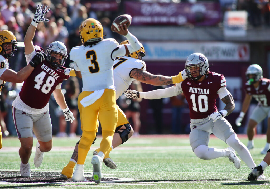 Joshua Wood throws under pressure from Isaac Keim and Styles Goodman