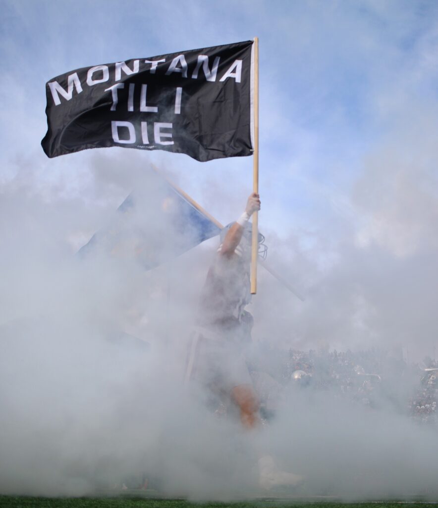 Montana Til I Die flag leads the Griz out