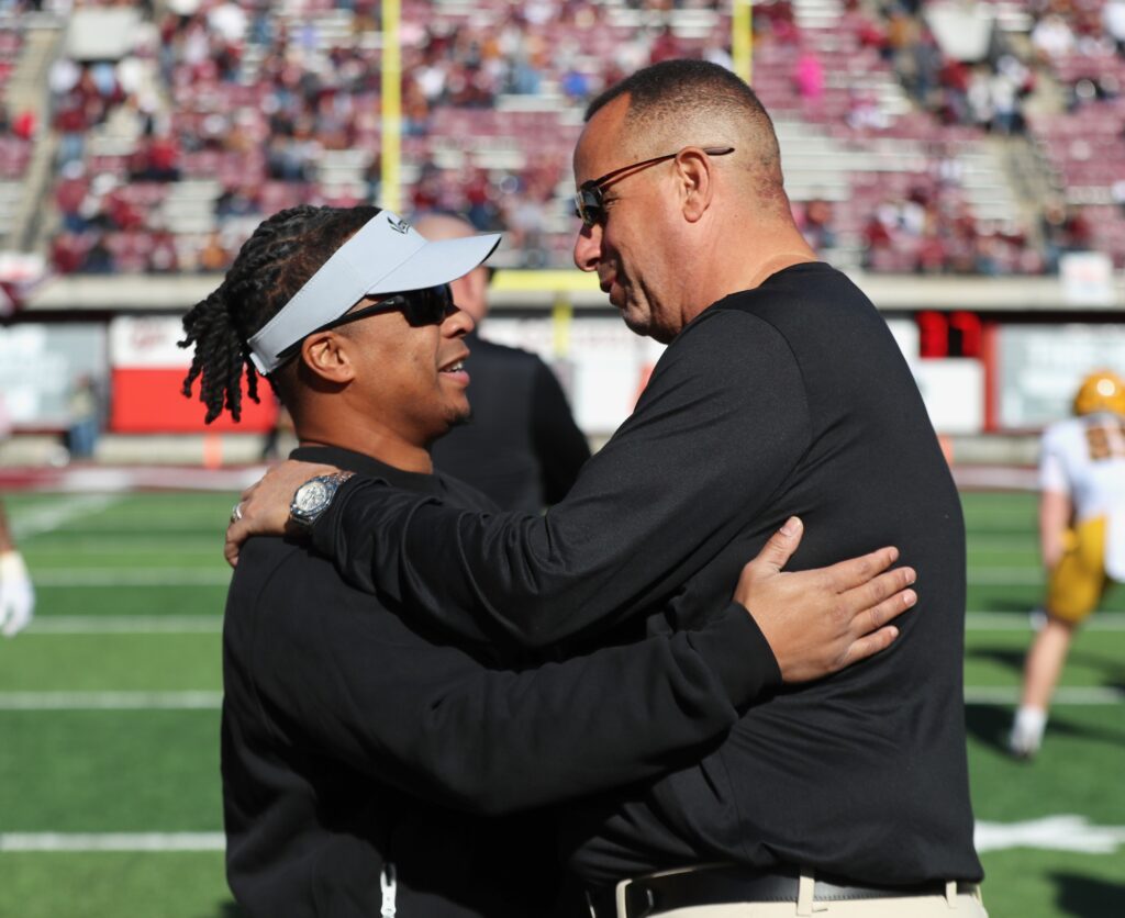 Thomas Ford Jr. and Bobby Kennedy embrace pregame