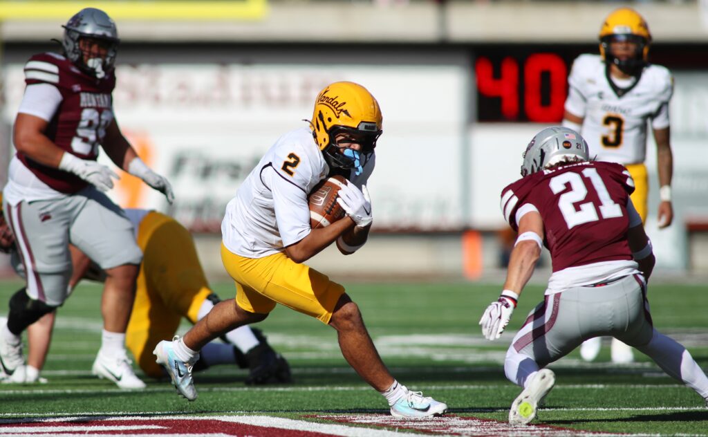 Vandals No. 2 runs past Griz No. 21