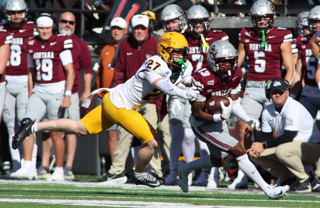 Vandals No. 27 dives at Griz ball carrier