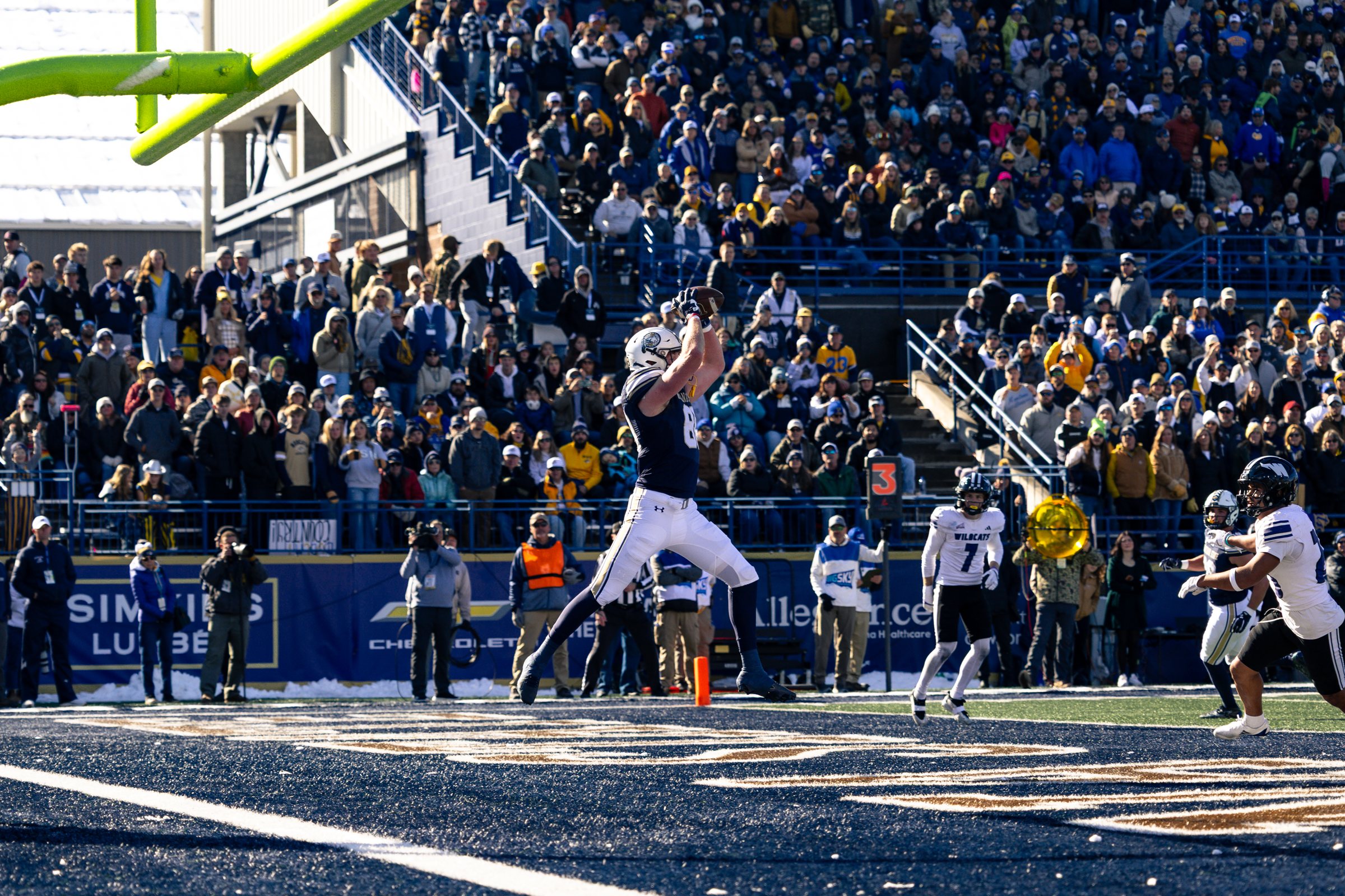 A Bobcat tight end leaps for a catch in the end zone