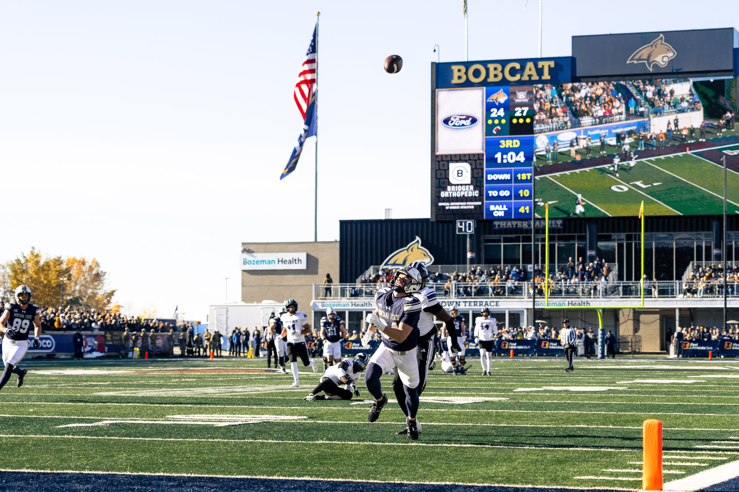 A Bobcat kickoff sails past the video board