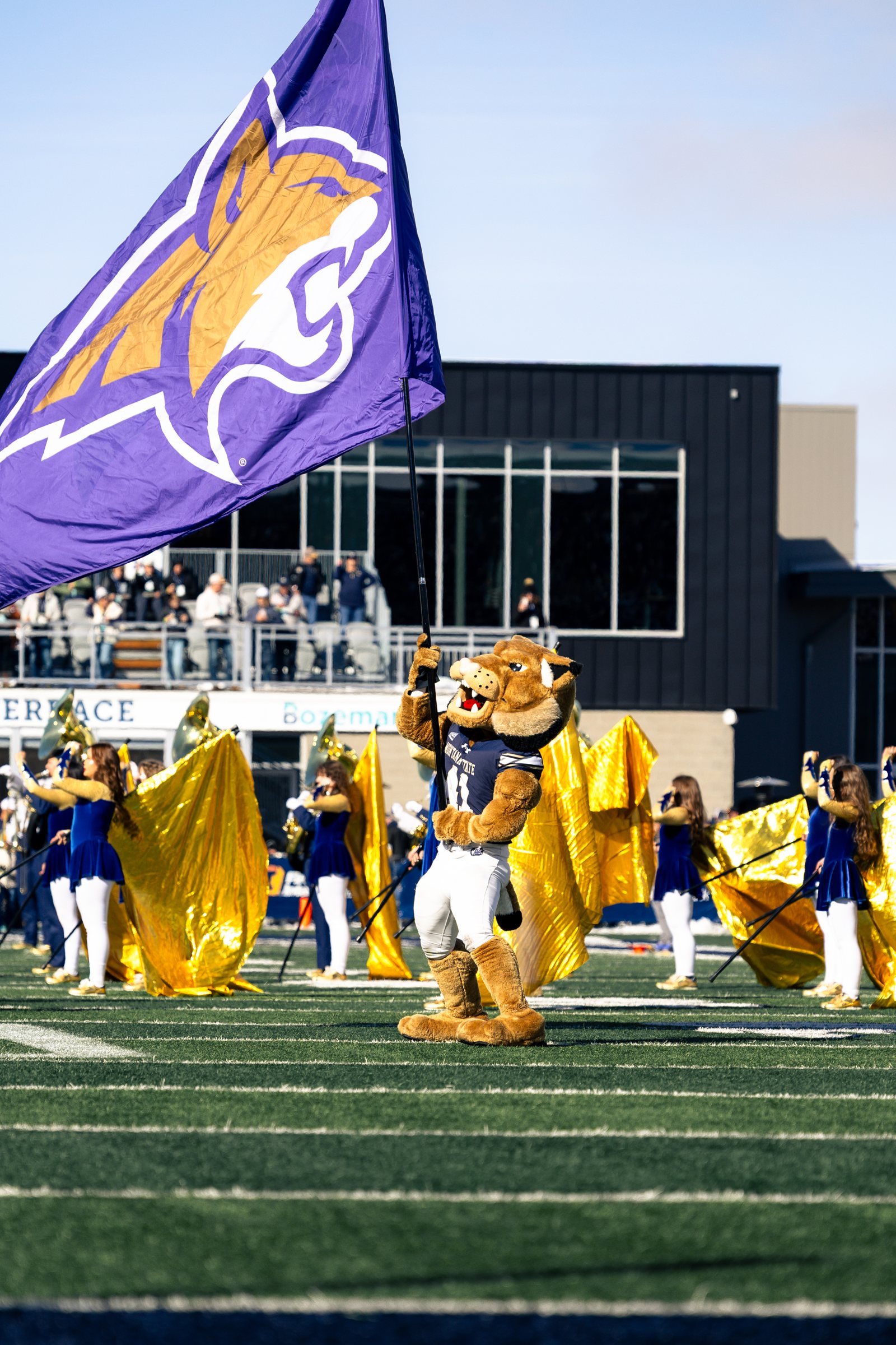 Champ waves the Bobcat flag before kickoff
