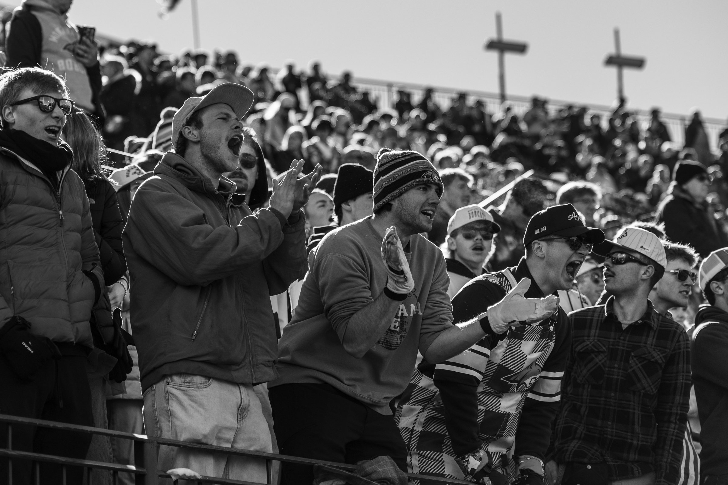 Bobcat students cheer from the student section in black and white